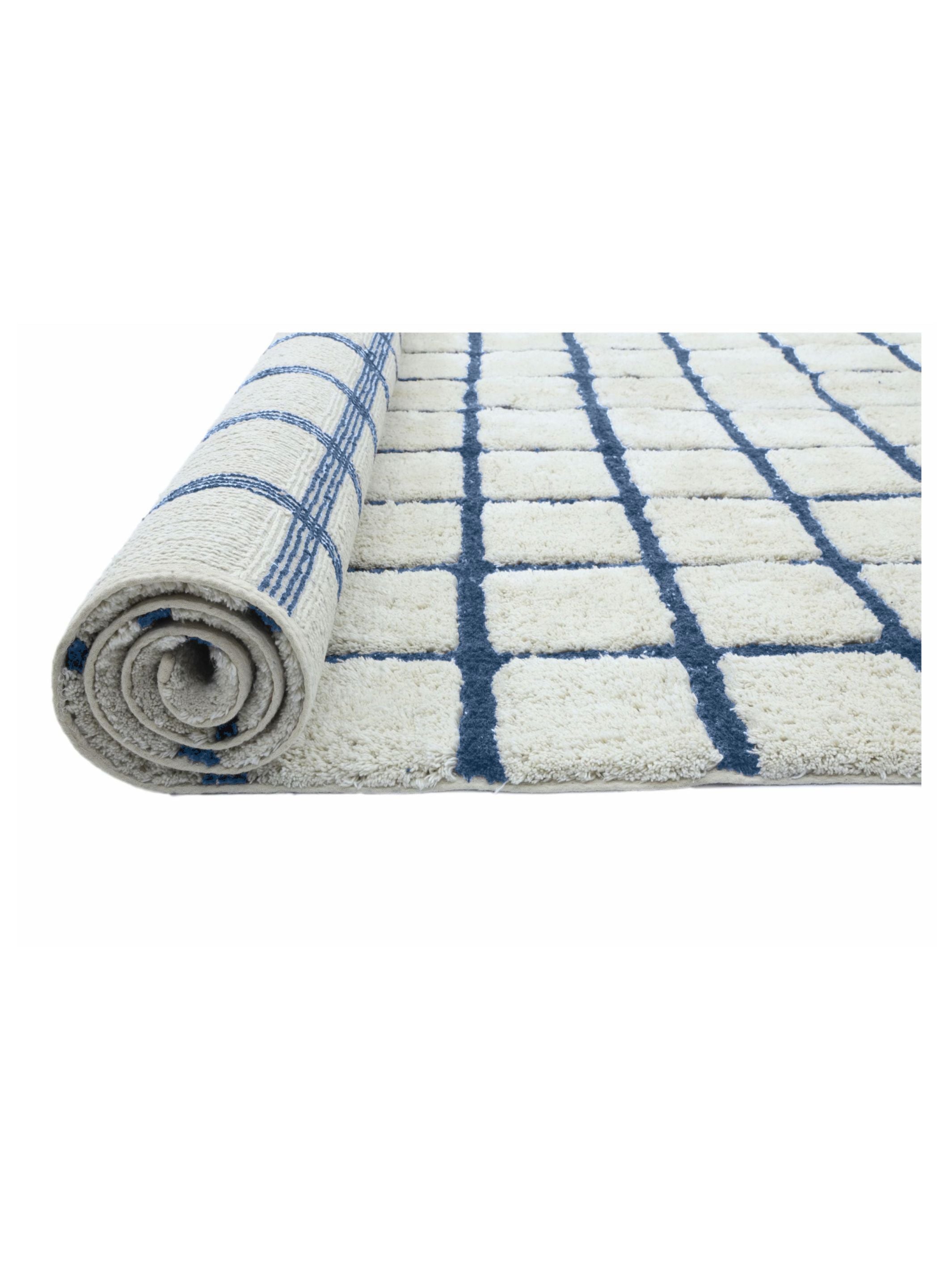 Roll of white bath mat with blue checkered pattern on a white background