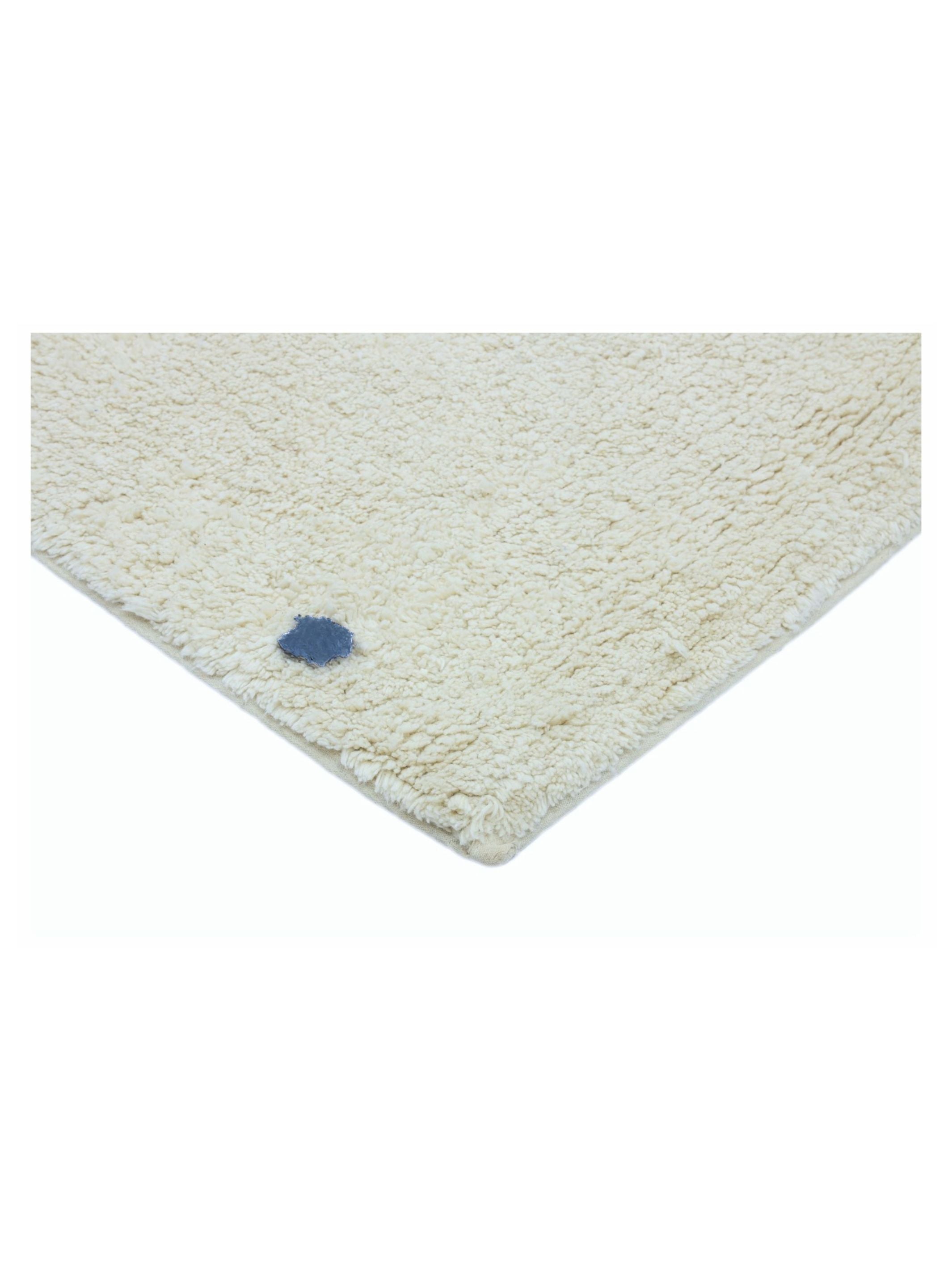 Natural rug with dusty blue polka dots on a white background