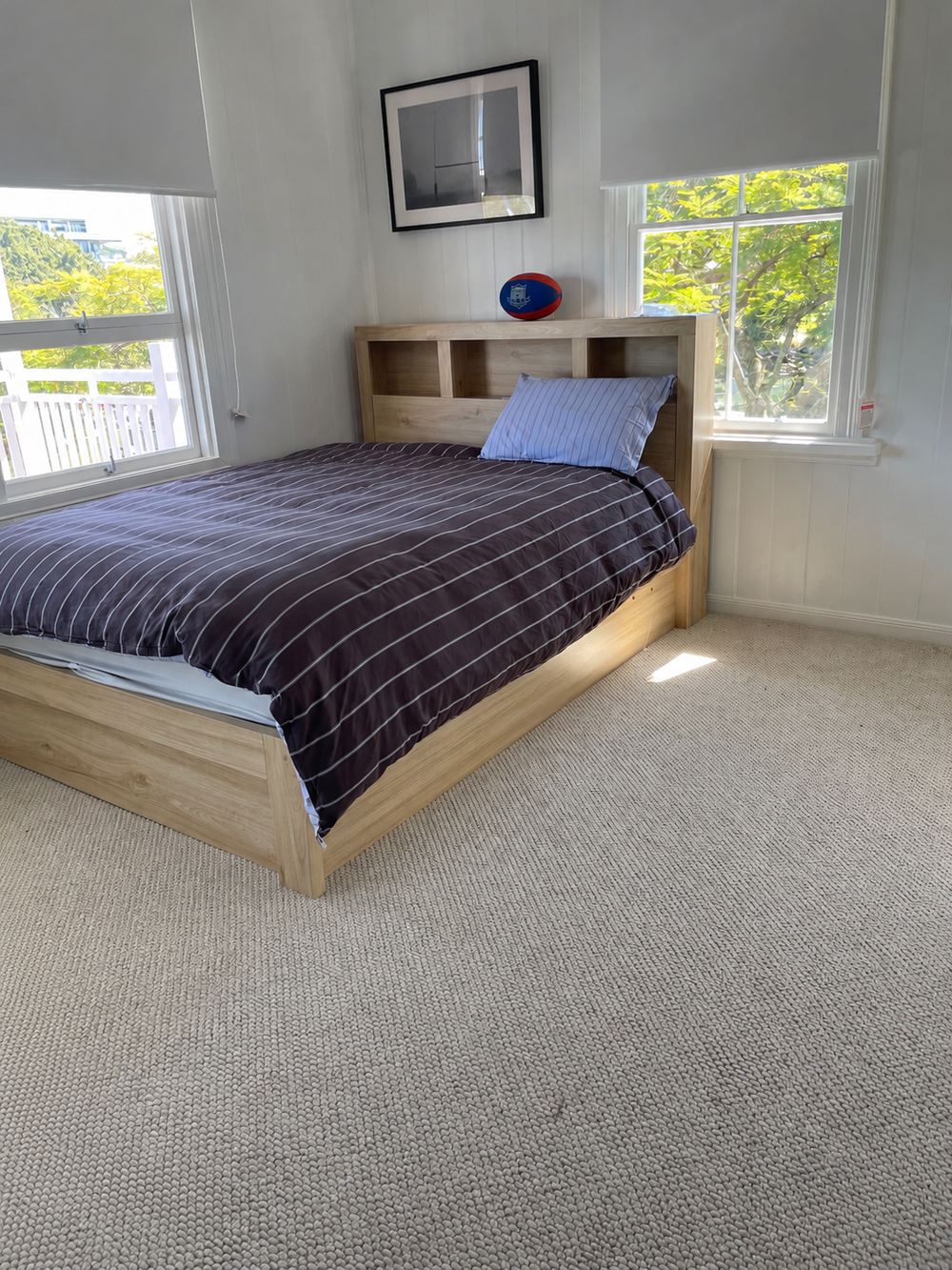 Bedroom before styling, with the existing timber bed and striped bedding