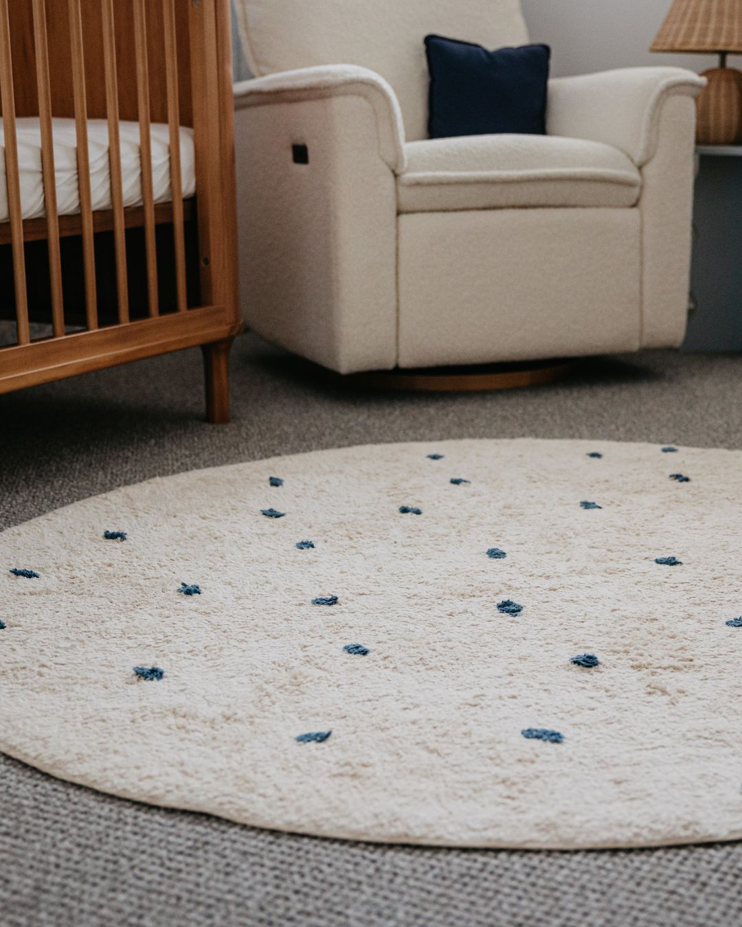 Round beige rug with blue accents in a living room setting
